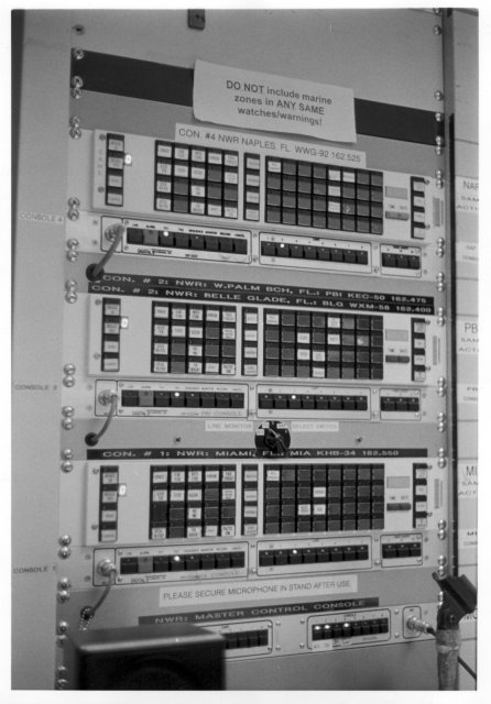 One of my interests is to photograph interesting phenomena associated with severe weather; falling heavy rain, hurricane winds, tornadoes, hail, etc.

Since I haven't managed to capture any of the above on film yet, here's the console with the buttons the National Weather Service in Miami pushes to alert the area's residents of such. It's gray and housed in the dead sexy industrial EIA racks of electronic love.

Note the presence of "Winter Storm" and "Blizzard". If either of those conditions actually exist here, trust me, I'll photograph them.