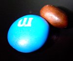 You know how at the very bottom of a bag of potato chips, you are left with downright useless kibble? That effect is apparently also present with M&M's. Shown near a normal M&M for comparison, the last one in the package was very unimpressive.