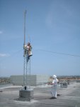 First section guyed, gin pole in place to position second. Chuck gets smaller.