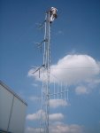 Rich mounts the Stati-Cats. Down below, the log periodic antenna (the one that looks like an outdoor TV antenna) is aimed at the NBC6 tower in Princeton. It'll be picking up our signal on 88.1, and the antennas above will be for the translator output on 95.3. The little tube midway above it is the power divider for the 3-bay Bext antenna. I'm the antenna, catching vibrations; you're the transmitter, give information...