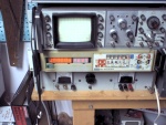 The most presentable part of my workroom. You do NOT want to see anything else. Trust me. Really. From top, old HP 60Mhz 'scope, Fluke 8520A (running its downright hypnotic display self-test), old power supply capable of, for no particularly good reason, about 48 volts @ 10 amps.