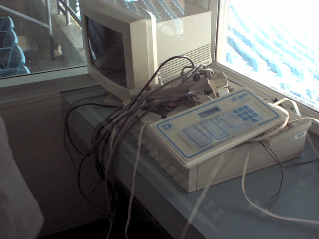 Scoreboard control console and PC... objects on top are, in no particular order; keypad for scoreboard control, floppy disk head-cleaner, kanoodled wiring.