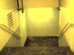 The little s***hole tunnel that leads down to the field. Out of view is a turn in the tunnel, and a pair of steel doors, thoroughly corroded, which required me to do a nifty flying kick to force them open.  The floor is a spongy rubber material, which has collected lots of water --- imagine the worst mold smell you've ever smelled, then multiply that by two...